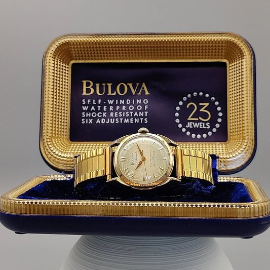 Boîtier montre automatique vintage Bulova 23 Jewels Self-Winding 1955, cadran champagne/crème. Icône horlogère.