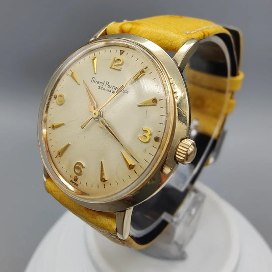 Couronne de montre Girard-Perregaux Sea-Hawk vintage 1960. Mouvement manuel, cadran champagne. Détail montre collection.