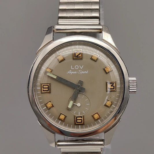 Vue boîtier Lov Aqua-Sport 1970, montre automatique vintage, cadran gris champagne. Élégance intemporelle.