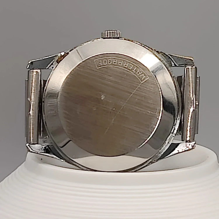 Montre vintage Tissot Visodate Camping 1962 automatique, cadran champagne, vue de fond.