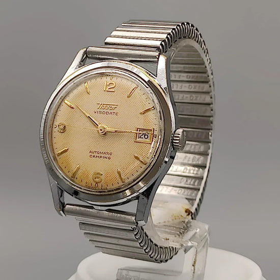 Détail couronne montre vintage Tissot Visodate Camping automatique 1962, cadran champagne.