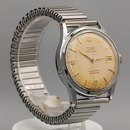 Cadran montre vintage Tissot Visodate Camping automatique 1962 champagne. Élégance intemporelle pour femme.